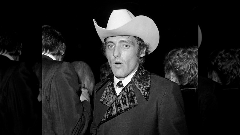 A black and white photo of Dennis Hopper at a Oscars afterparty in 1970