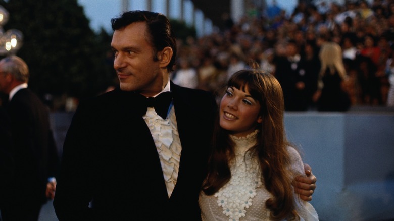 Hugh Hefner with his arm around Barbi Benton on the Oscars red carpet in 1970
