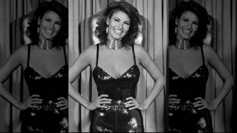 Raquel Welch smiling and posing with her hands on her hips at the 1979 Academy Awards