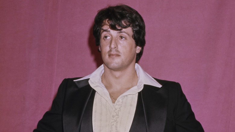 Sylvester Stallone pictured wearing his large open collar in the Oscars press room at the 1977 awards