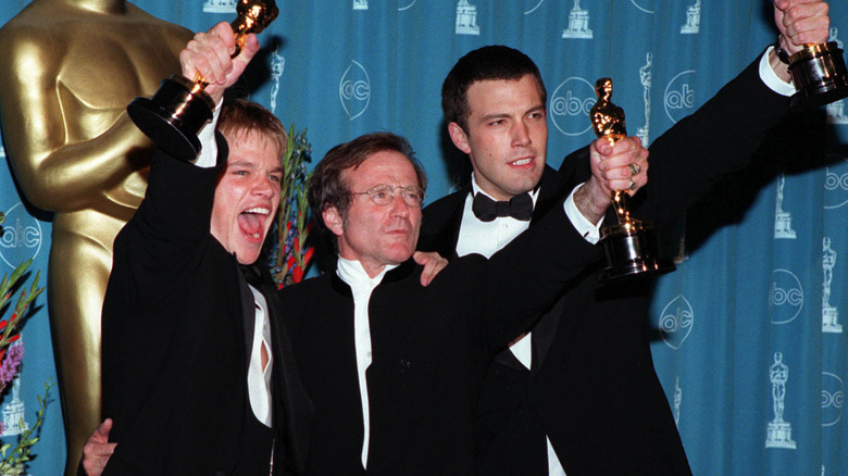 Matt Damon, Robin Williams, and Ben Affleck holding up Academy Awards