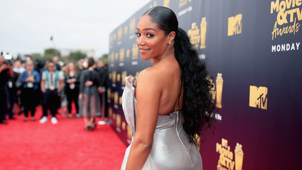 Tiffany Haddish looks over her shoulder on the red carpet