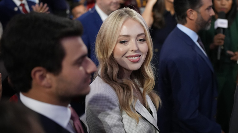 Tiffany Trump smiling while looking to the side in a white blazer