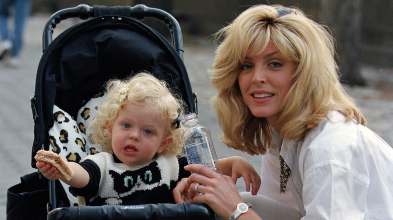 Tiffany Trump as a toddler poses in a stroller besides Marla Maples