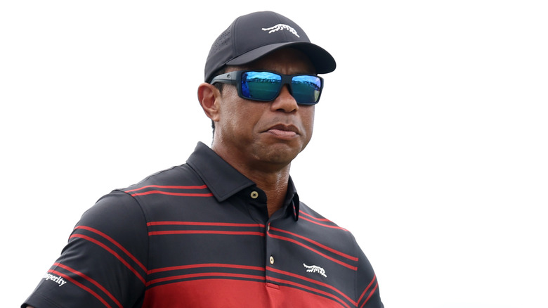 Tiger Woods pouting in sunglasses and a cap