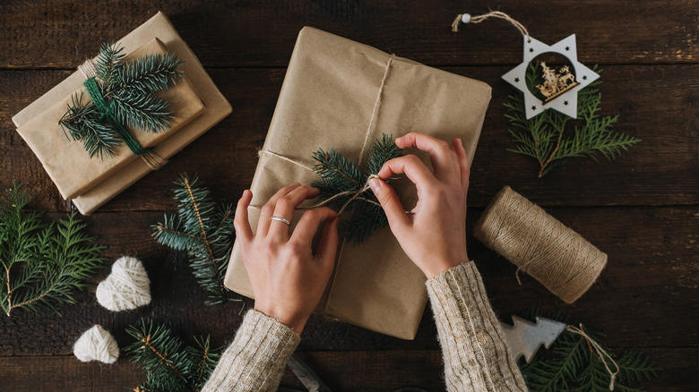 Woman wrapping a Christmas with twine