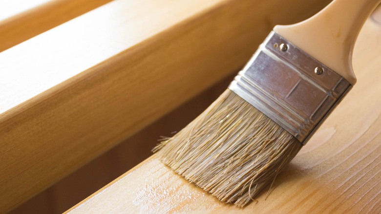 A paint brush polishing wood