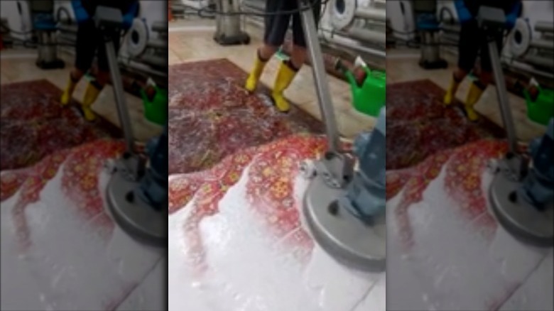Red rug being washed