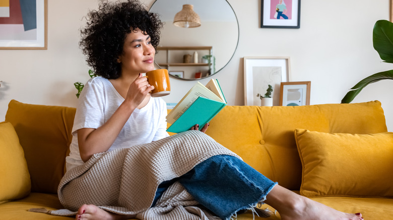 woman with book and mug