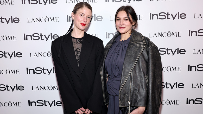 Gracie and Maggie McGraw posing on step-and-repeat