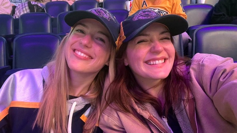 Maggie and Gracie McGraw smiling in selfie at hockey game