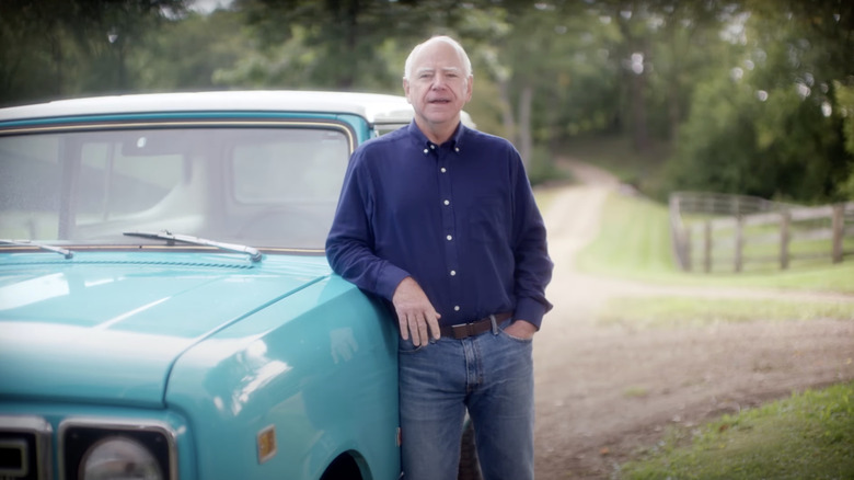 Tim Walz stands next to a pickup truck
