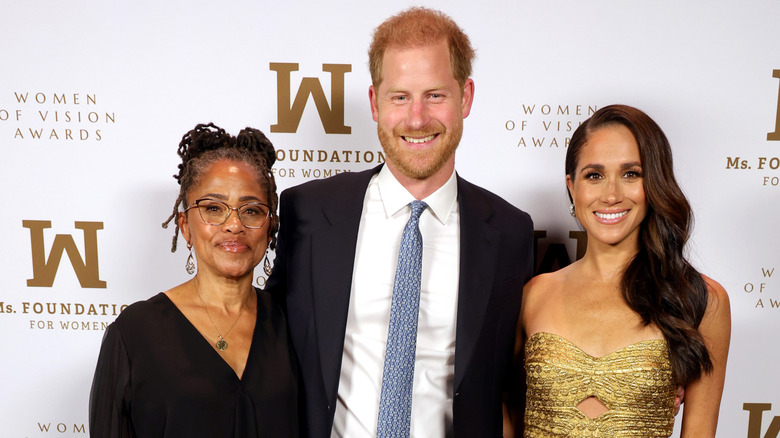 Doria Ragland posing with Harry and Meghan