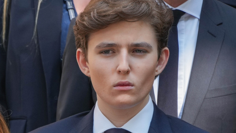 Barron Trump looks off to one side