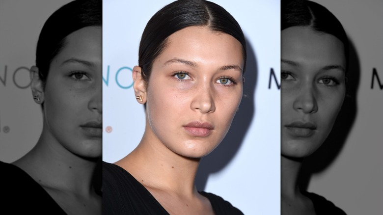 Bella Hadid without makeup and middle-parted, slicked hair