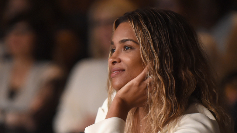 Ciara without makeup in a white outfit and casual hairdo