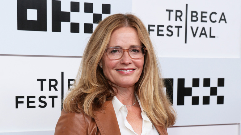 Elisabeth Shue in glasses and brown leather jacket