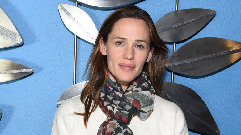 Jennifer Garner without makeup in a white sweater and printed scarf