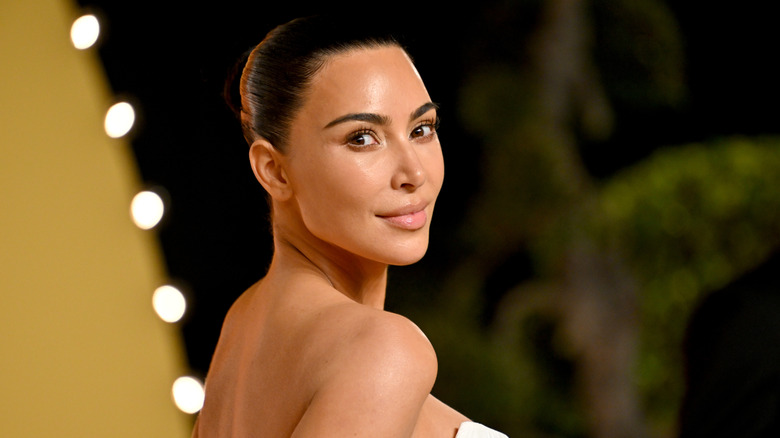 Kim Kardashian in a no-makeup look with slicked back hair