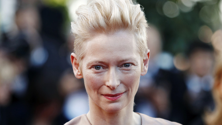 Tilda Swinton wearing red lipstick and her signature blonde updo
