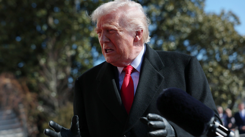 Donald Trump looking emotional while surrounded by reporters