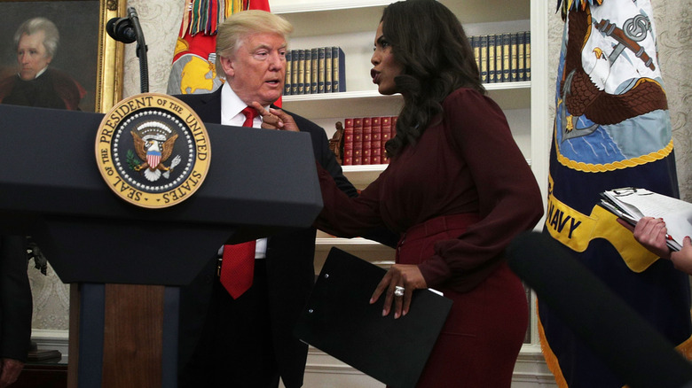 Omarosa Manigault Newman seemingly scolding someone out of view while Donald Trump looks on