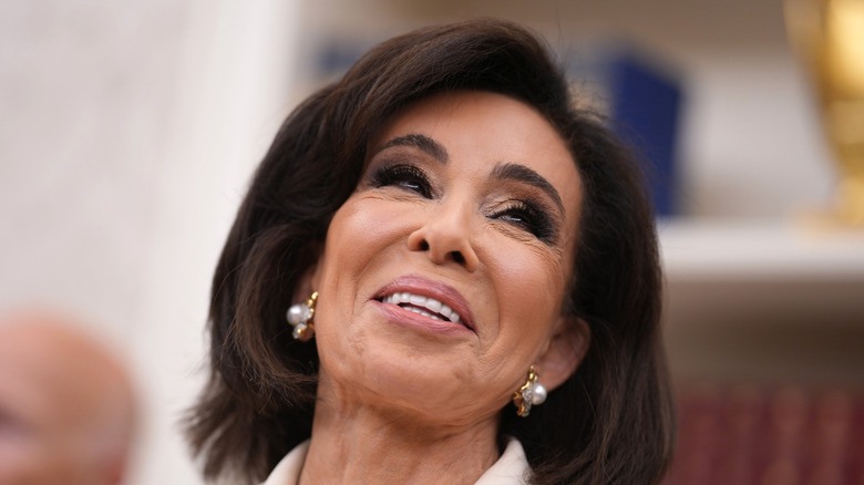 Judge Jeanine Pirro laughing with her head tilted to the side