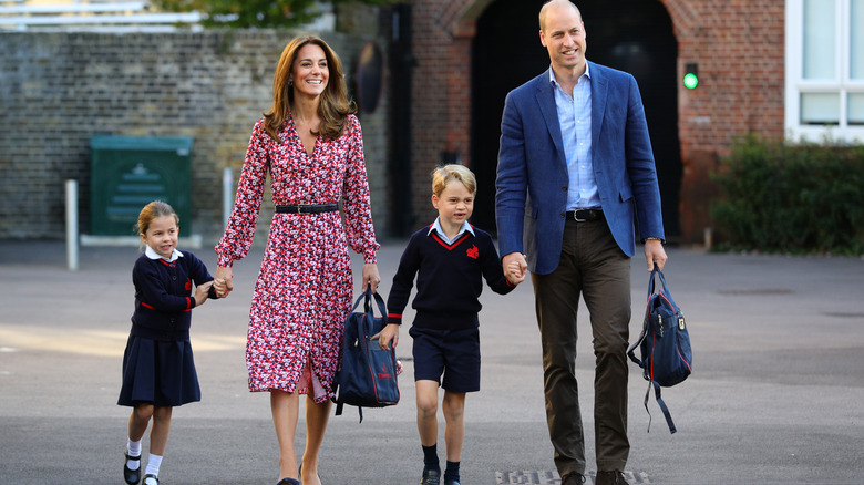 The Prince and Princess of Wales walking with children 