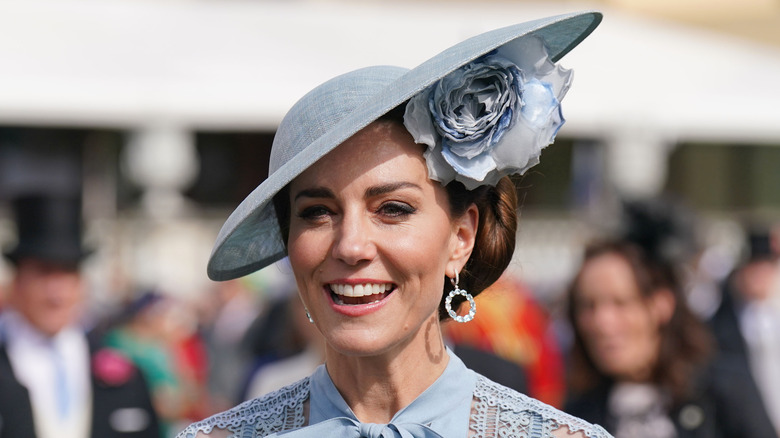 Kate Middleton smiling in a blue hat