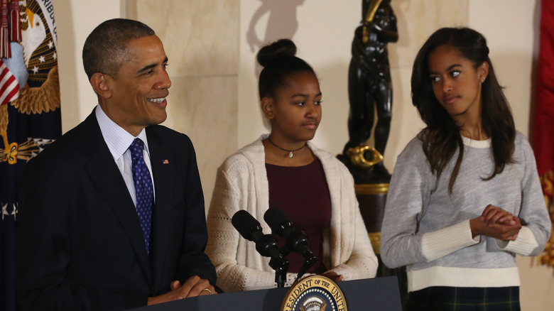 Barack, Sasha and Malia Obama stand side by side at the 2014 Thanksgiving ceremony