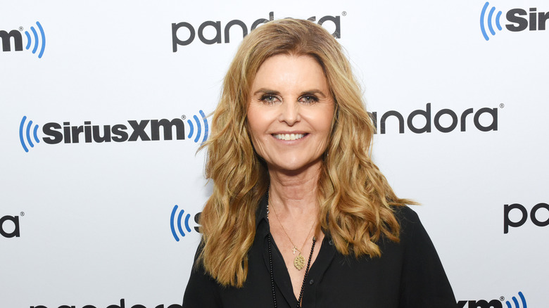 Maria Shriver smiling in black dress