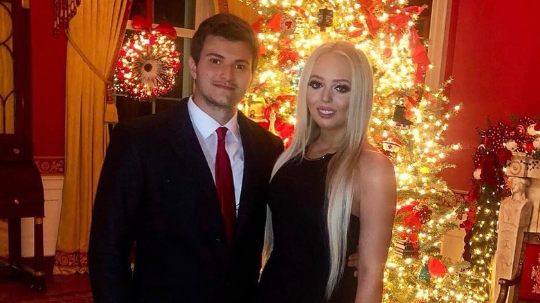 Michael Boulos and Tiffany Trump pose together in front of a Christmas tree (2019)