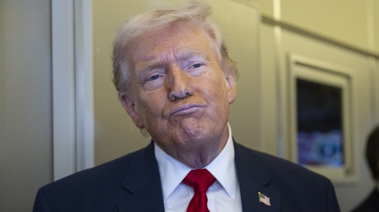 Donald Trump squints and presses his lips together on Air Force One.