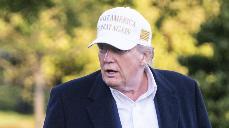 Donald Trump white MAGA cap looking right