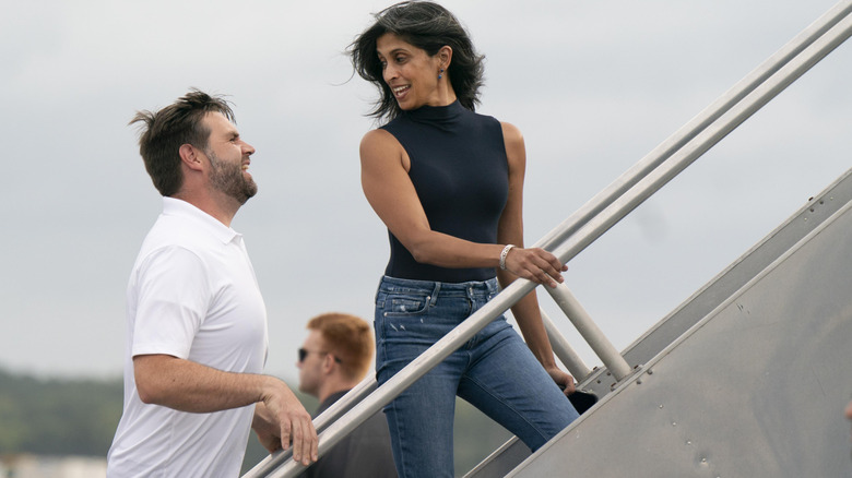 Usha Vance looking over her shoulder at JD Vance as they board a plane.