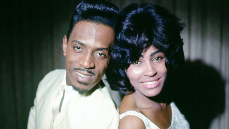 Ike Turner and Tina Turner smiling back to back