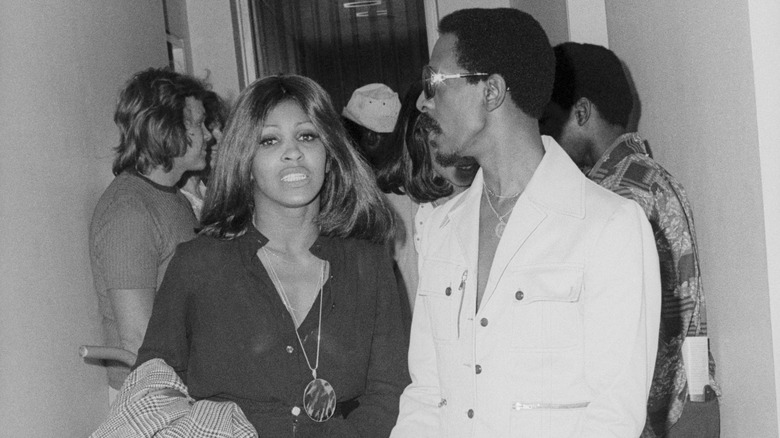 Tina Turner in hallway with Ike Turner and others in 1970