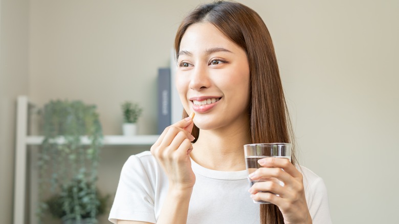 Woman taking supplement