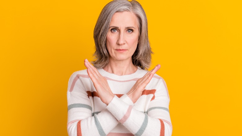 Woman crossing her arms in front of her
