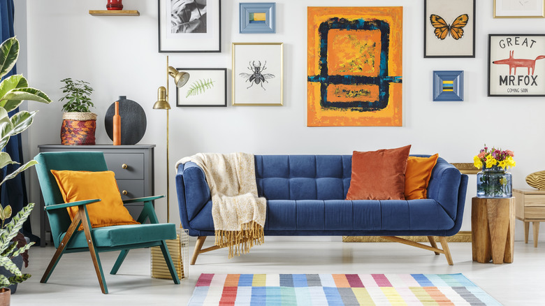 Living room with blue couch and colorful gallery wall