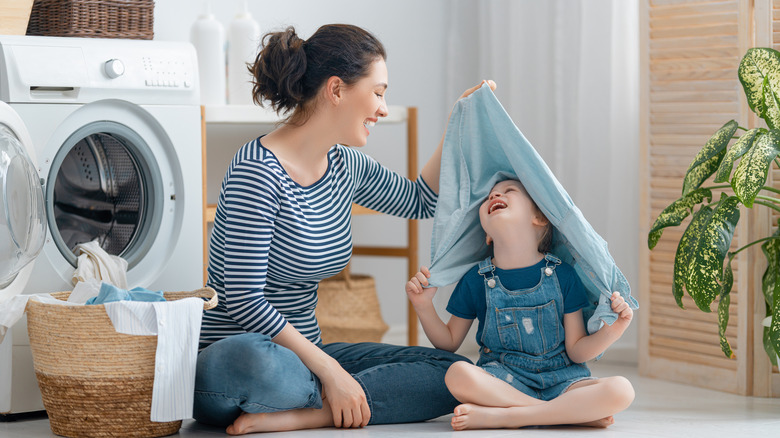 A mom and daughter doing laundry