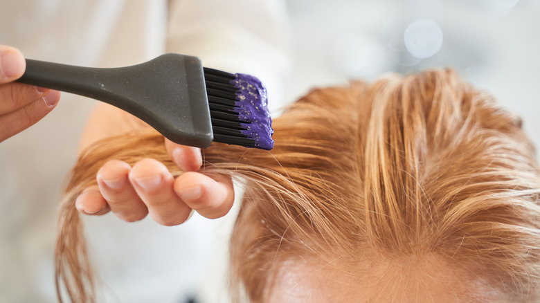 Girl getting hair dye on her hair