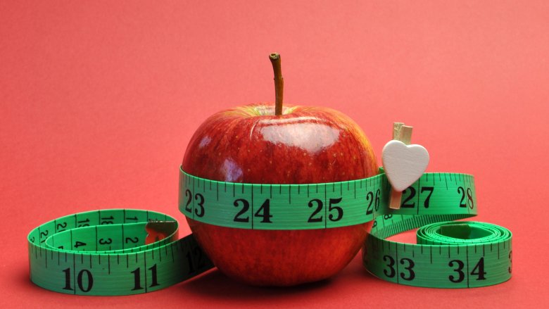 Apple with measuring tape