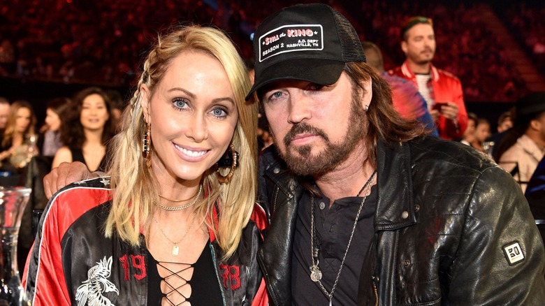 Tish and Billy Ray Cyrus posing