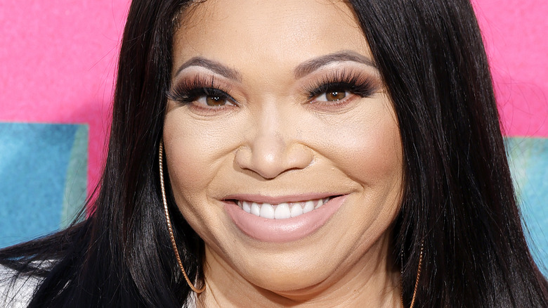 Tisha Campbell smiling hoop earrings