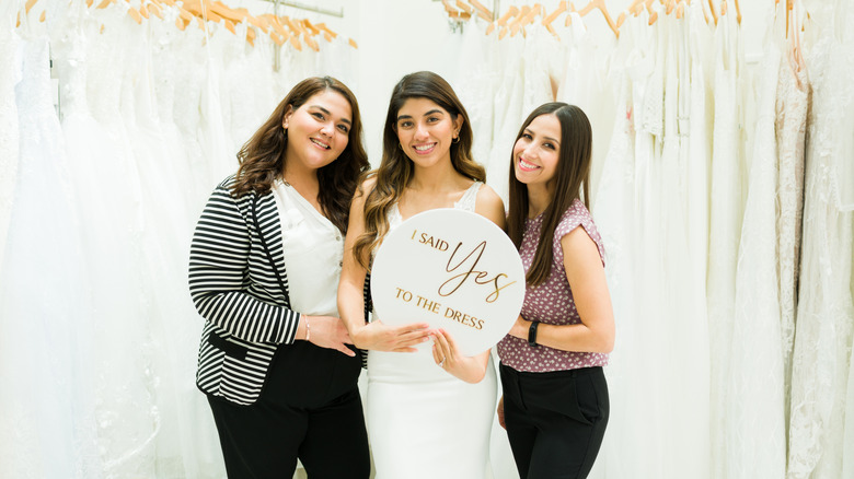 Woman trying on wedding dress