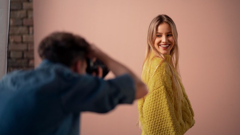 A woman smiling at a photo shoot