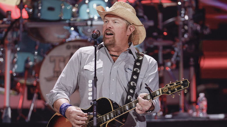 Toby Keith performing on stage in 2021