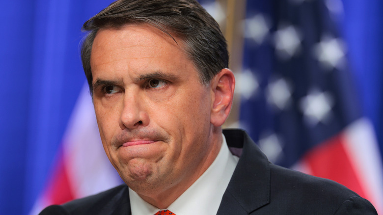 Todd Blanche licking his upper lip while looking up