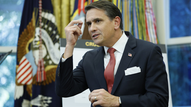 Todd Blanche delivering a speech in the Oval Office in a black suit